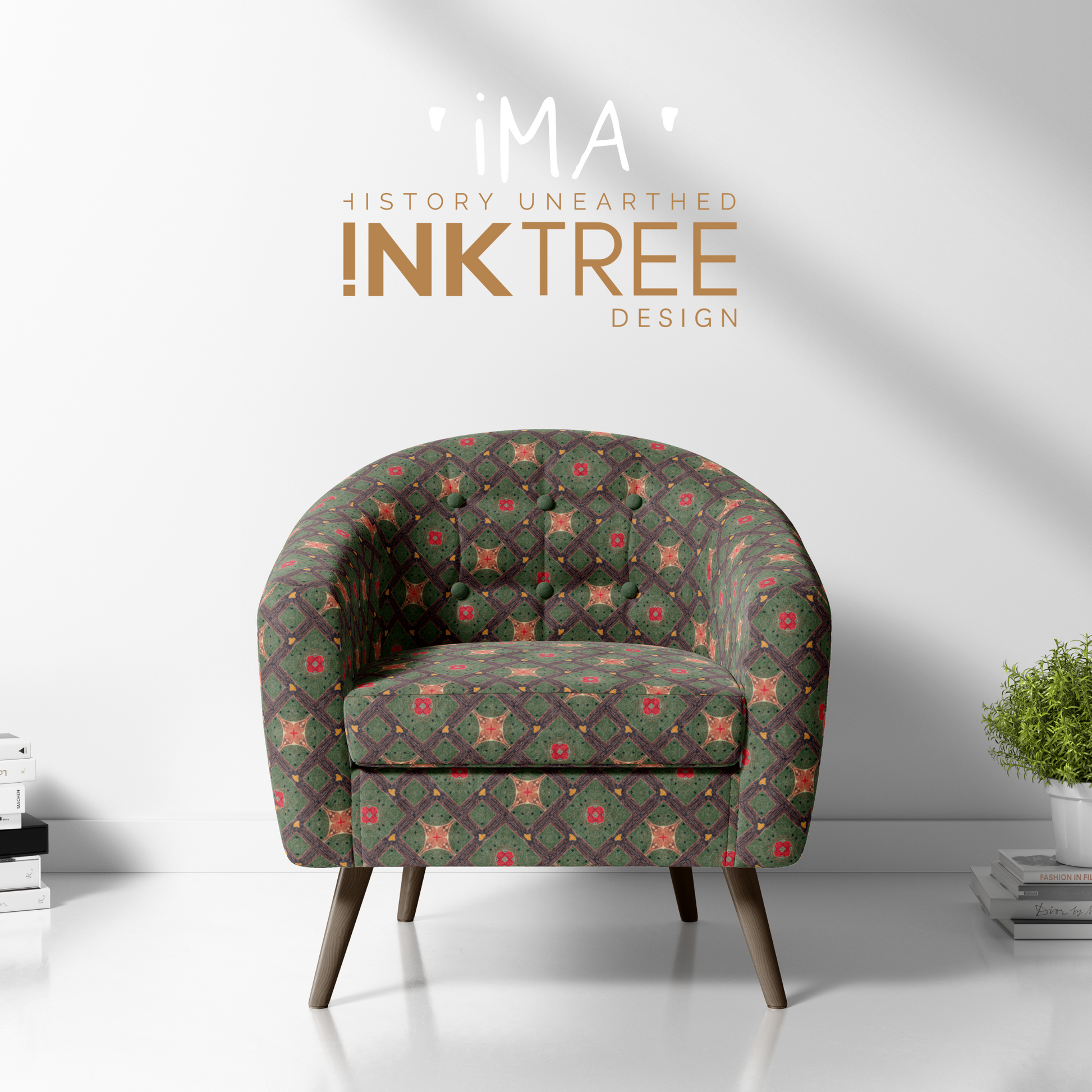 A club chair with a gold, black, blue, red, green and white oriental looking pattern on it with a white wall background and books and pot plant on the floor.  There is a ima history unearthered ink tree design logo on it.