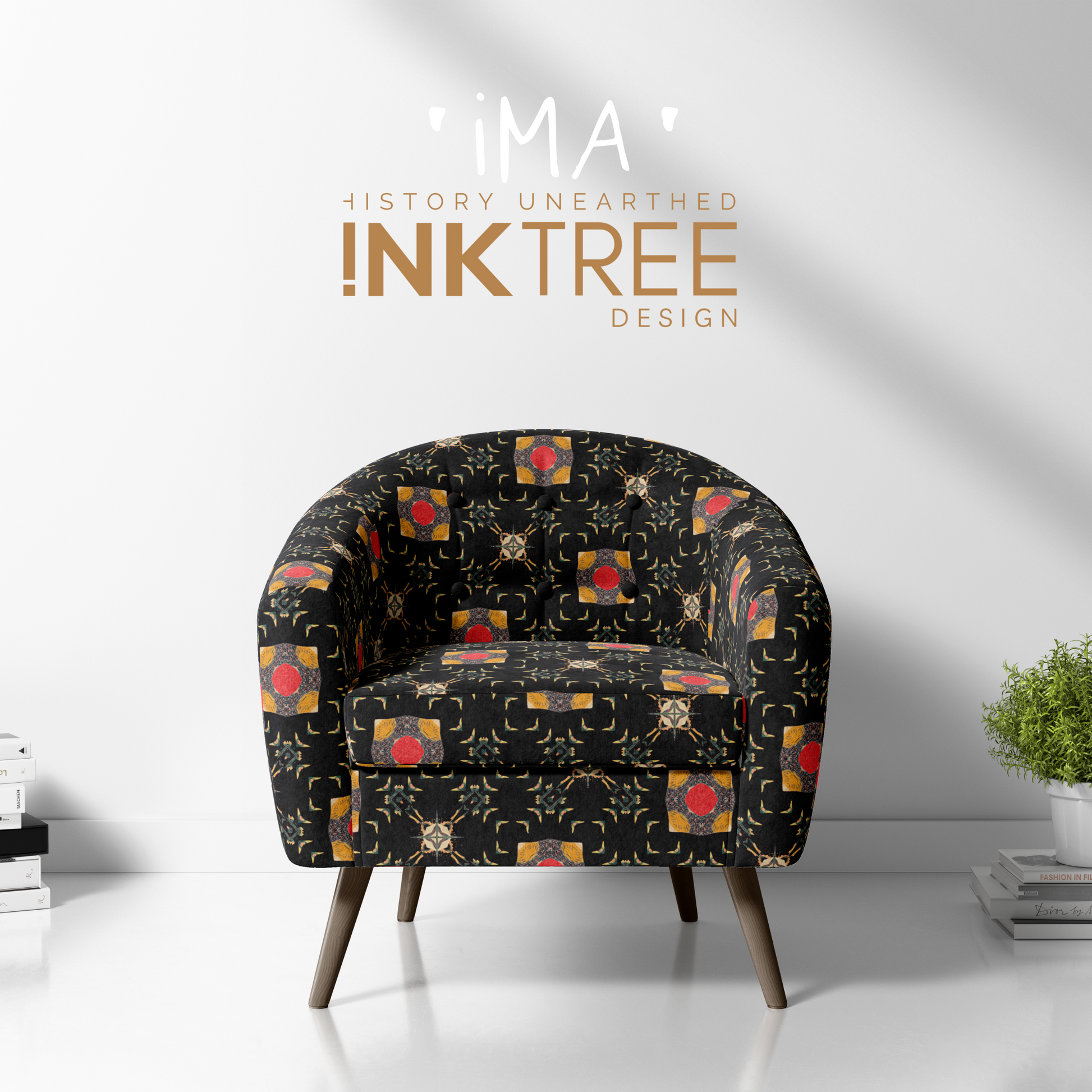 A club chair with a gold, black, blue, red, green and white oriental looking pattern on it with a white wall background and books and pot plant on the floor.  There is a ima history unearthered ink tree design logo on it