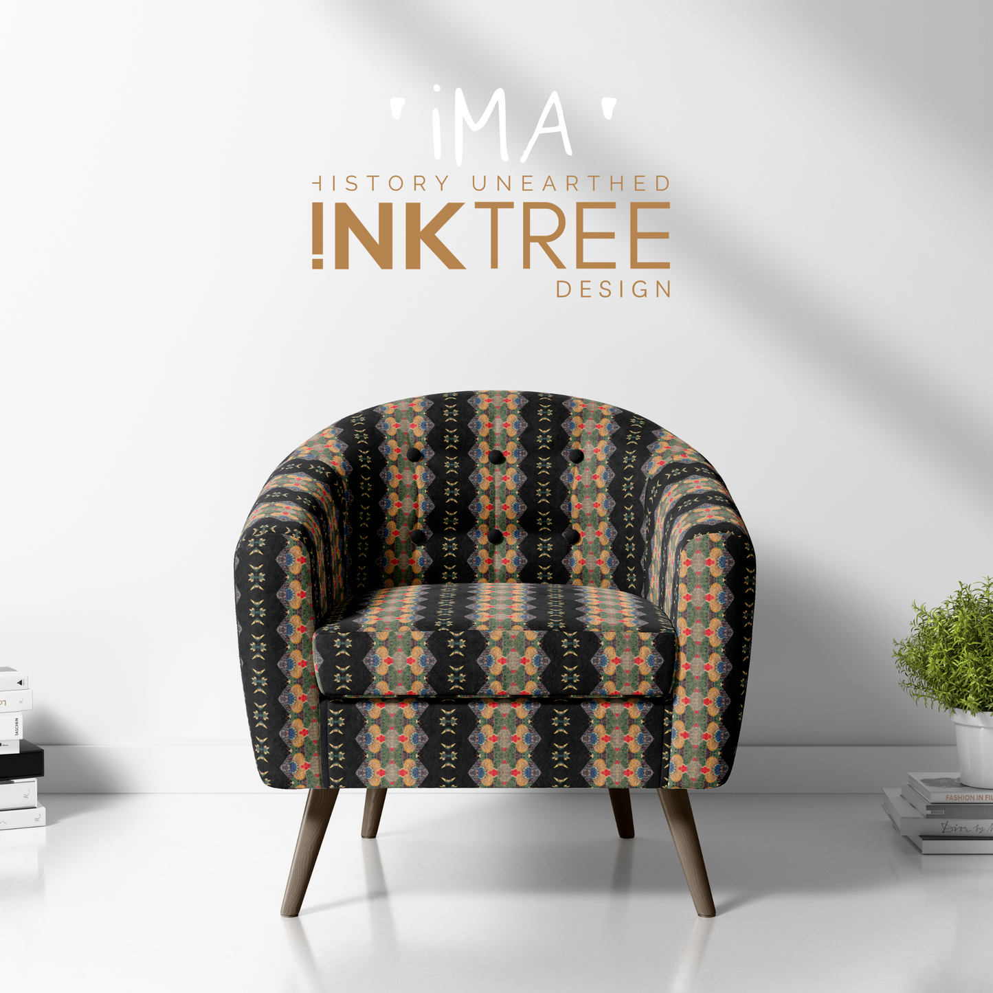 A club chair with a gold, black, blue, red, green and white oriental looking pattern on it with a white wall background and books and pot plant on the floor.  There is a ima history unearthered ink tree design logo on 