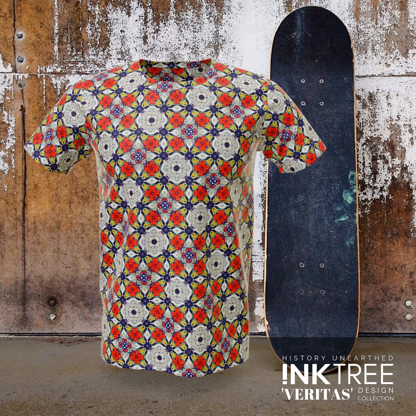 A blue, grey and red floral t'shirt, with a skateboard and rusty wall background.